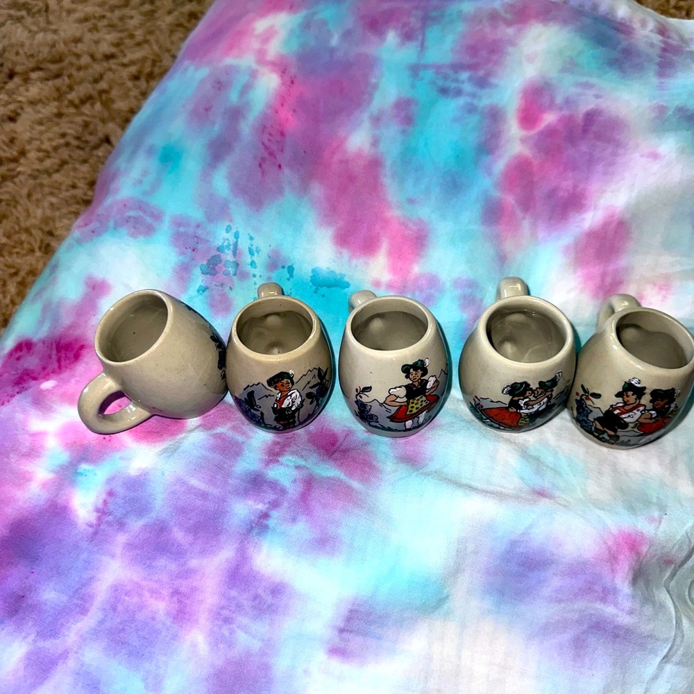 Tiny little collectors cups with handles .